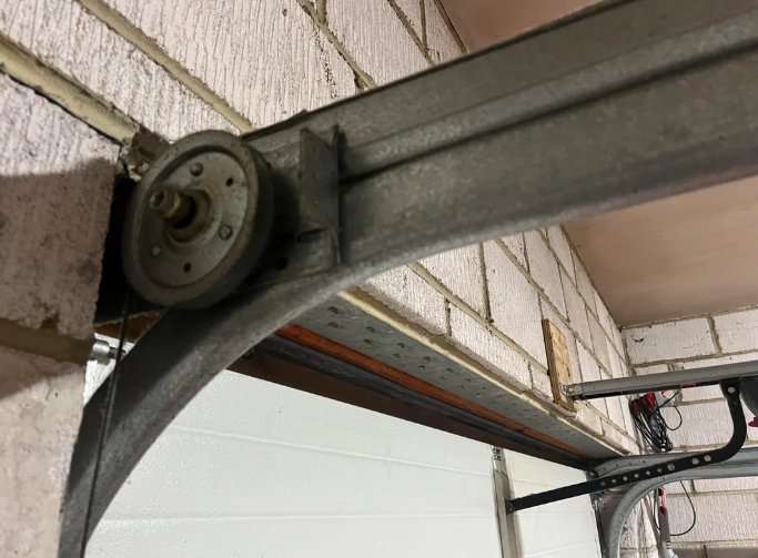 A professional technician performing garage door track repair in Fort Lauderdale, FL, ensuring smooth operation and safety. Enhance your home with expert garage door repair services