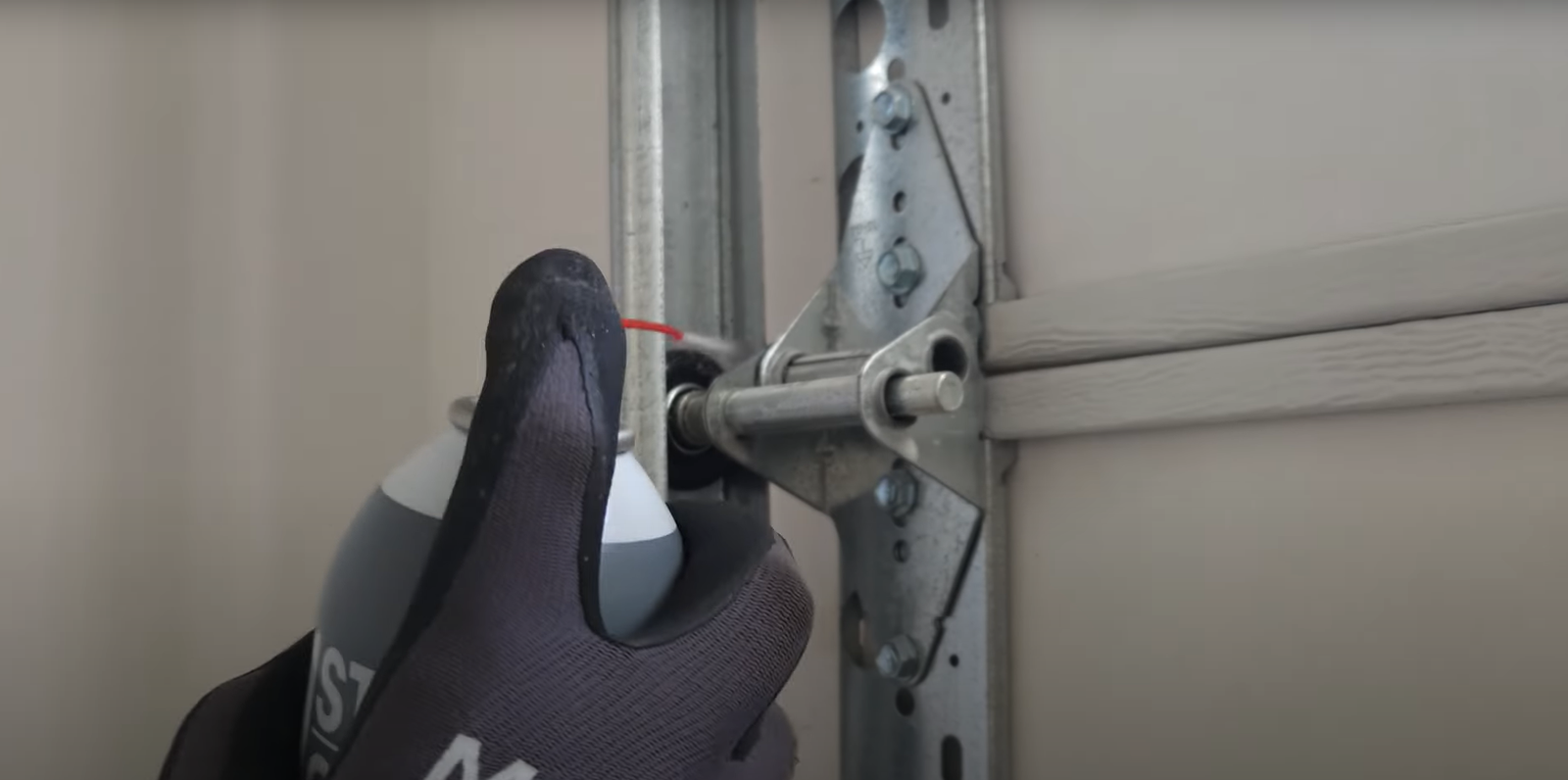 Professional technician repairing a noisy garage door in Fort Lauderdale, FL to ensure smooth and quiet operation.