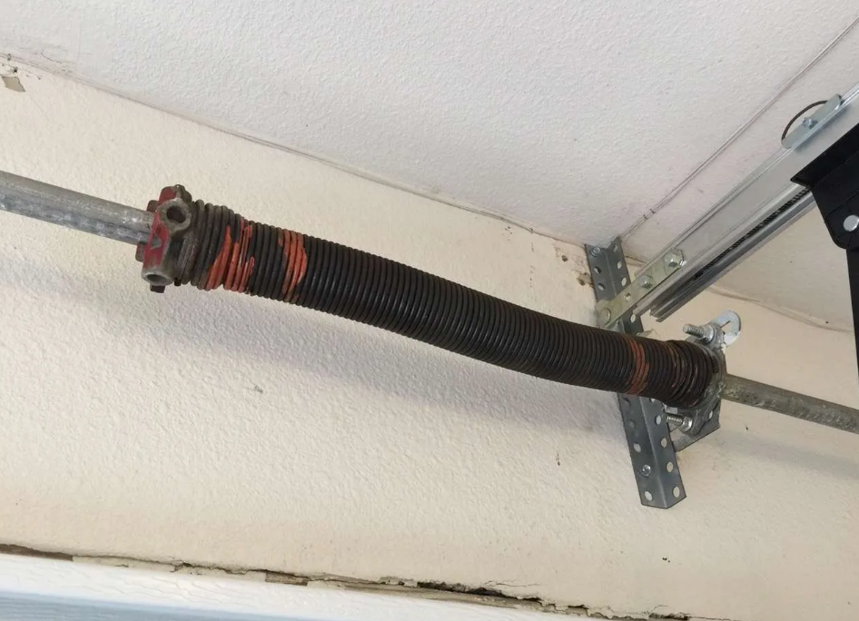 Image showing a professional technician performing garage door spring repair in Fort Lauderdale, FL, emphasizing safety and precision to enhance functionality and longevity of the garage door system.