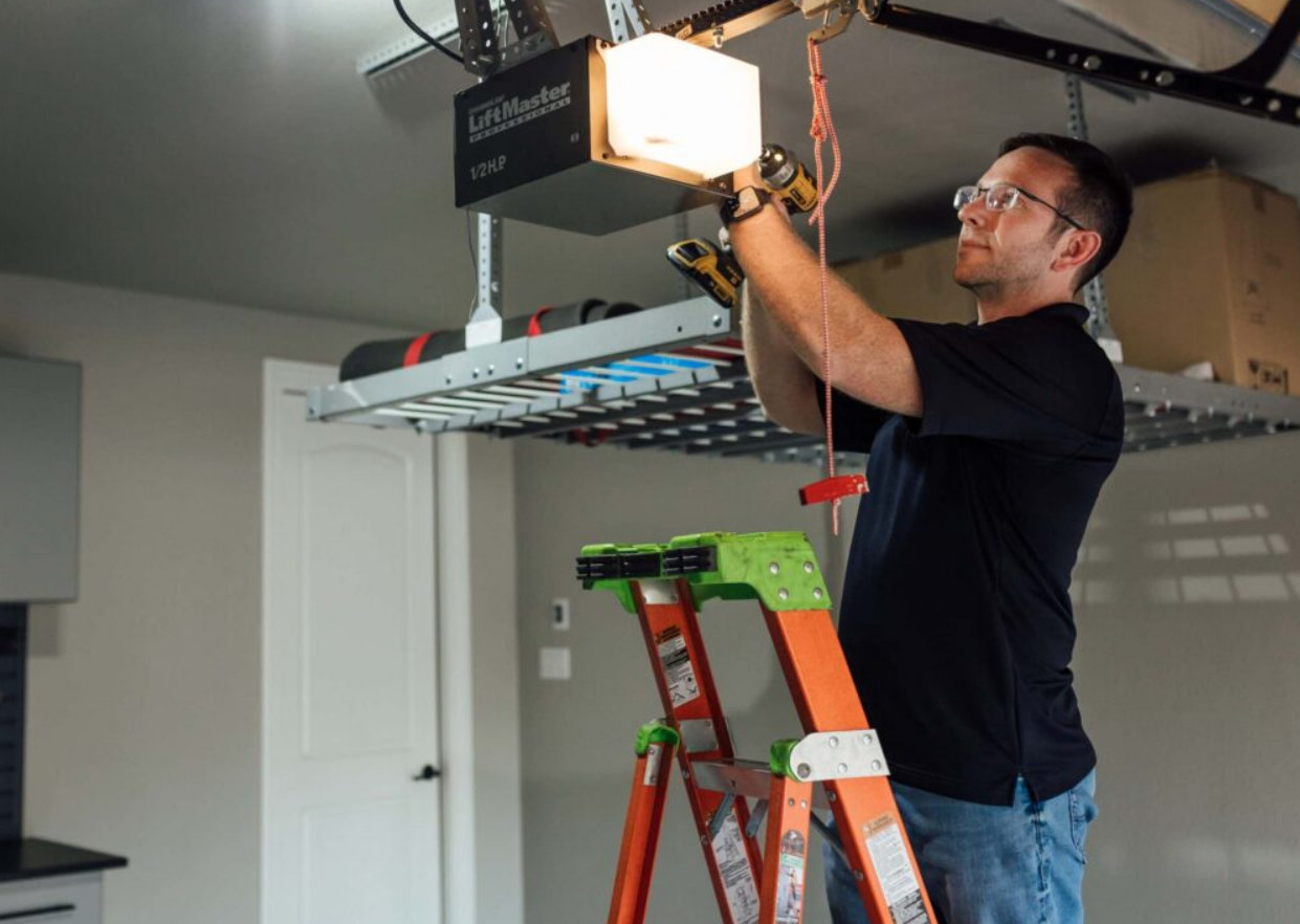 a professional technician performing garage door opener installation in Fort Lauderdale, FL. Highlighting expert garage door repair services for better functionality and security.
