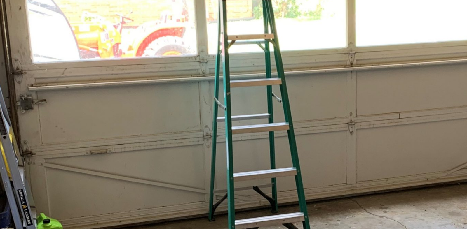 a technician performing garage door panel repair in Fort Lauderdale, FL, highlighting expert services provided by Fort Lauderdale FL Garage Door Repair Services.