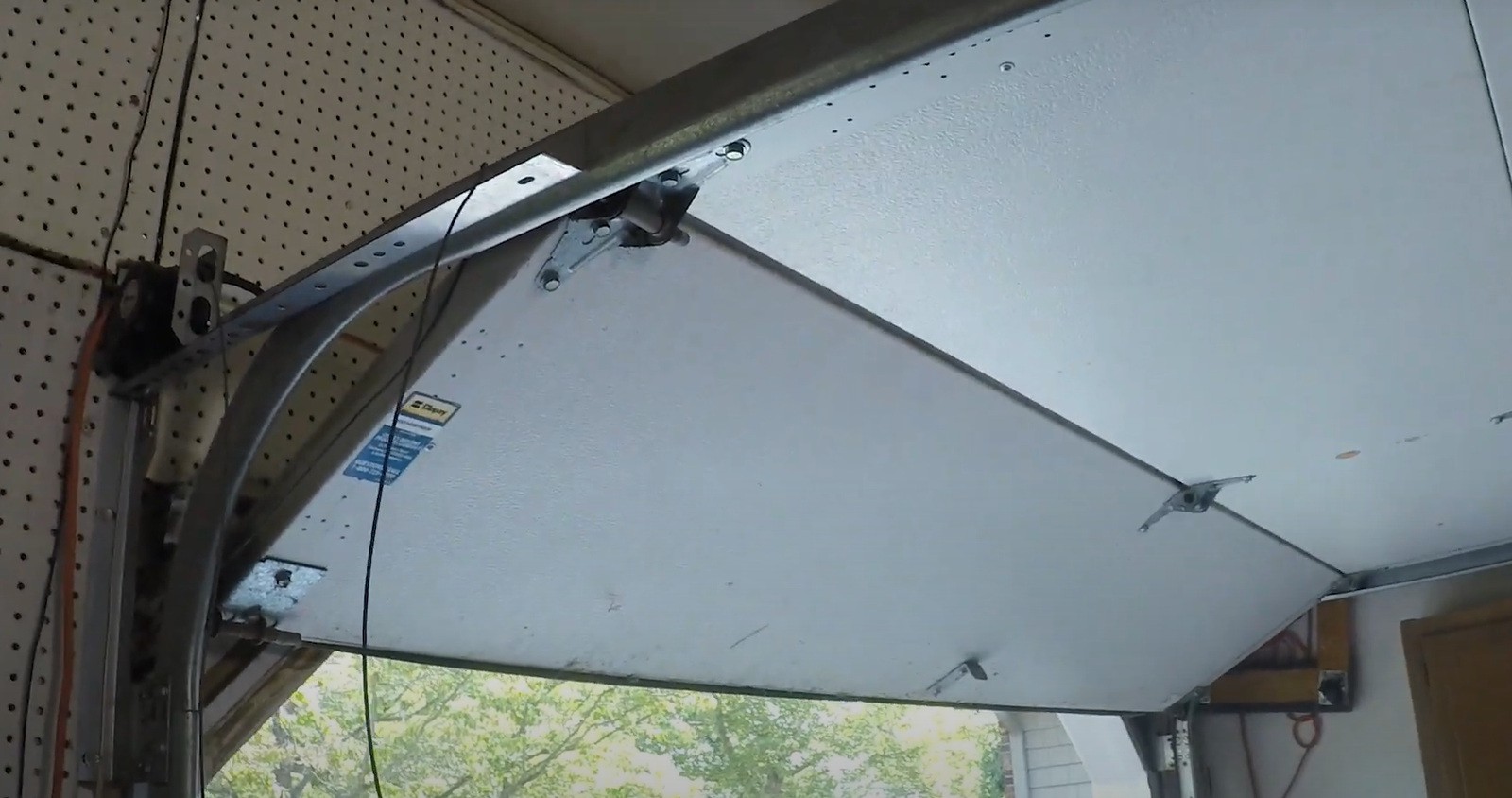 a technician performing garage door track repair in Fort Lauderdale, FL, showcasing professional repair services for optimal garage door functionality.