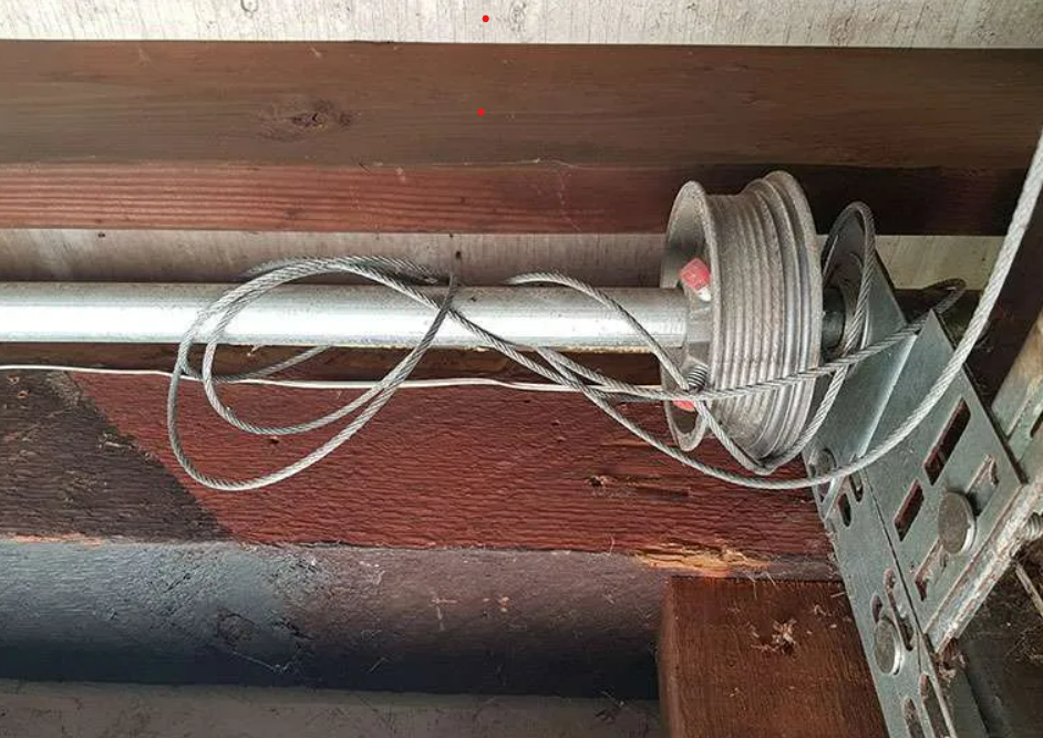 Technician repairing a garage door cable in Fort Lauderdale, FL - Fort Lauderdale Garage Door Repair Services.